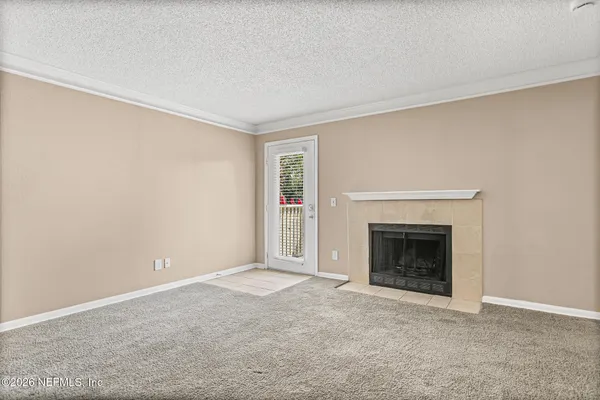 a view of an empty room with a fireplace