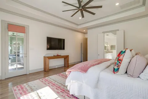 a bedroom with a bed and a flat screen tv