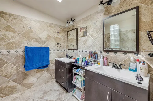a bathroom with a sink vanity granite and a mirror