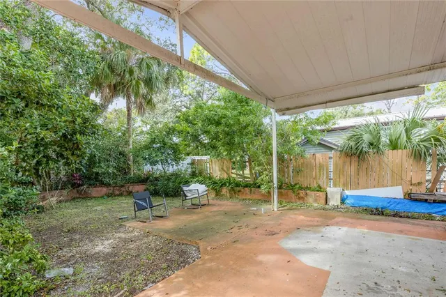 a backyard of a house with fountain plants and outdoor seating
