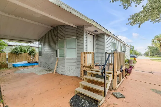a backyard of a house with wooden floor and fence