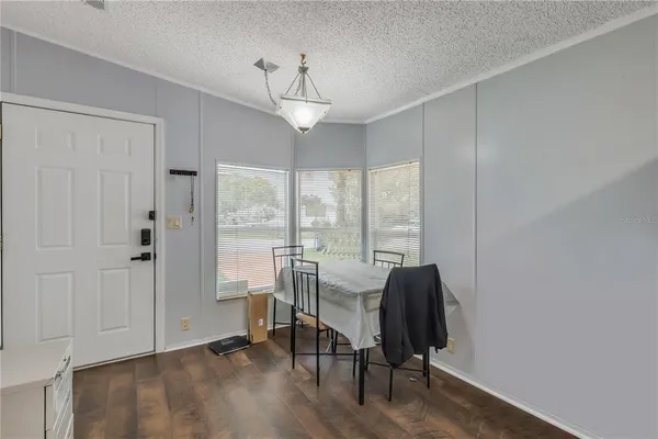 a view of a livingroom with furniture window and wooden floor