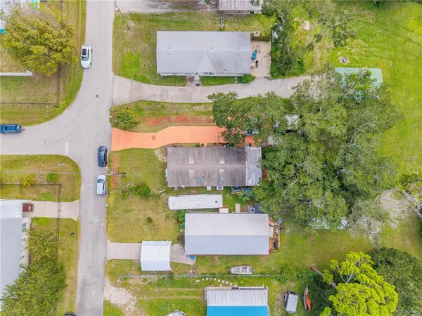 an aerial view of residential houses with outdoor space and swimming pool