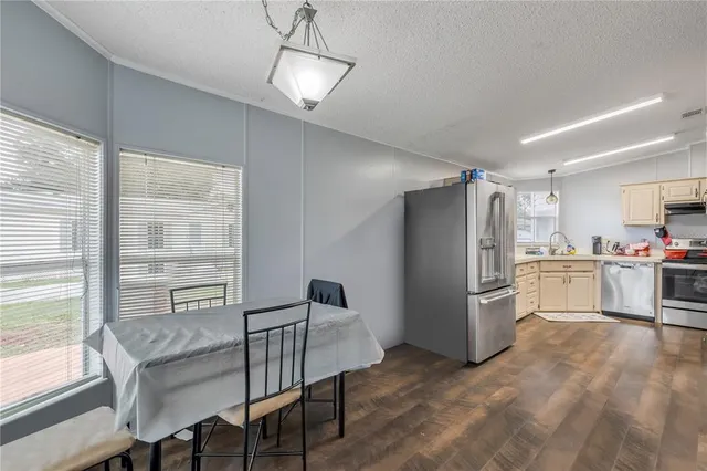 a kitchen with refrigerator cabinets and wooden floor
