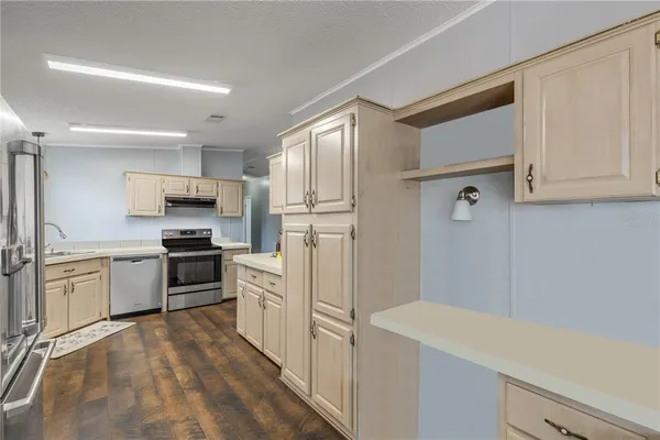 a kitchen with a refrigerator a stove top oven a sink and dishwasher