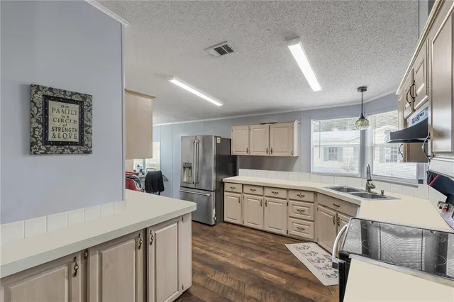 a kitchen with a sink appliances and cabinets