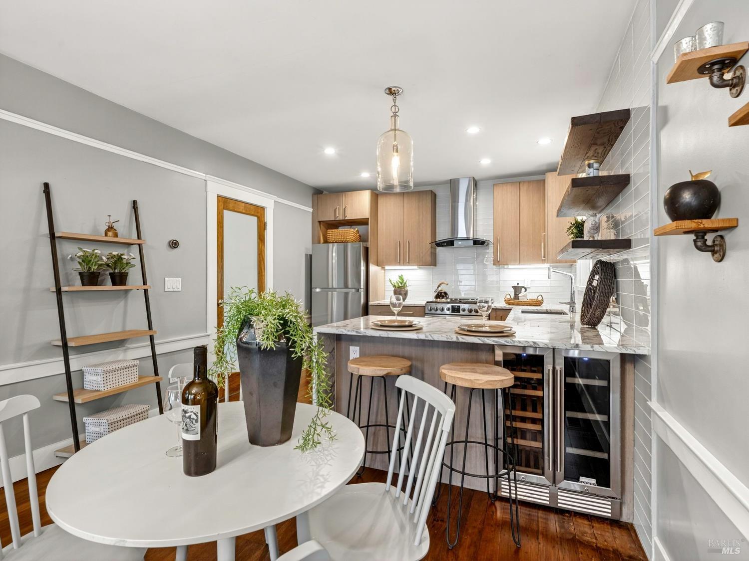2 Bulson Court Napa, CA 94559 - Photo 15 of 30 a kitchen with stainless steel appliances granite countertop a dining table chairs and white cabinets