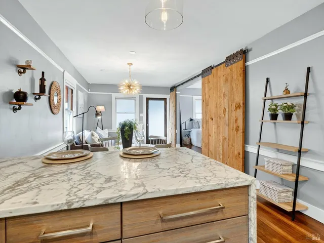 a kitchen with stainless steel appliances granite countertop a stove a refrigerator and a refrigerator