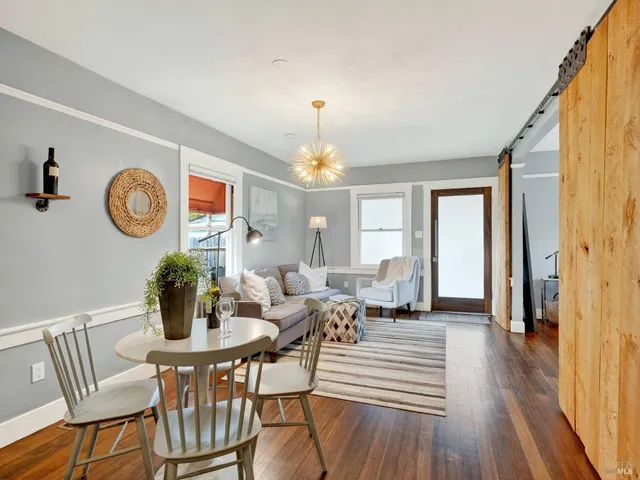 a living room with furniture and a chandelier