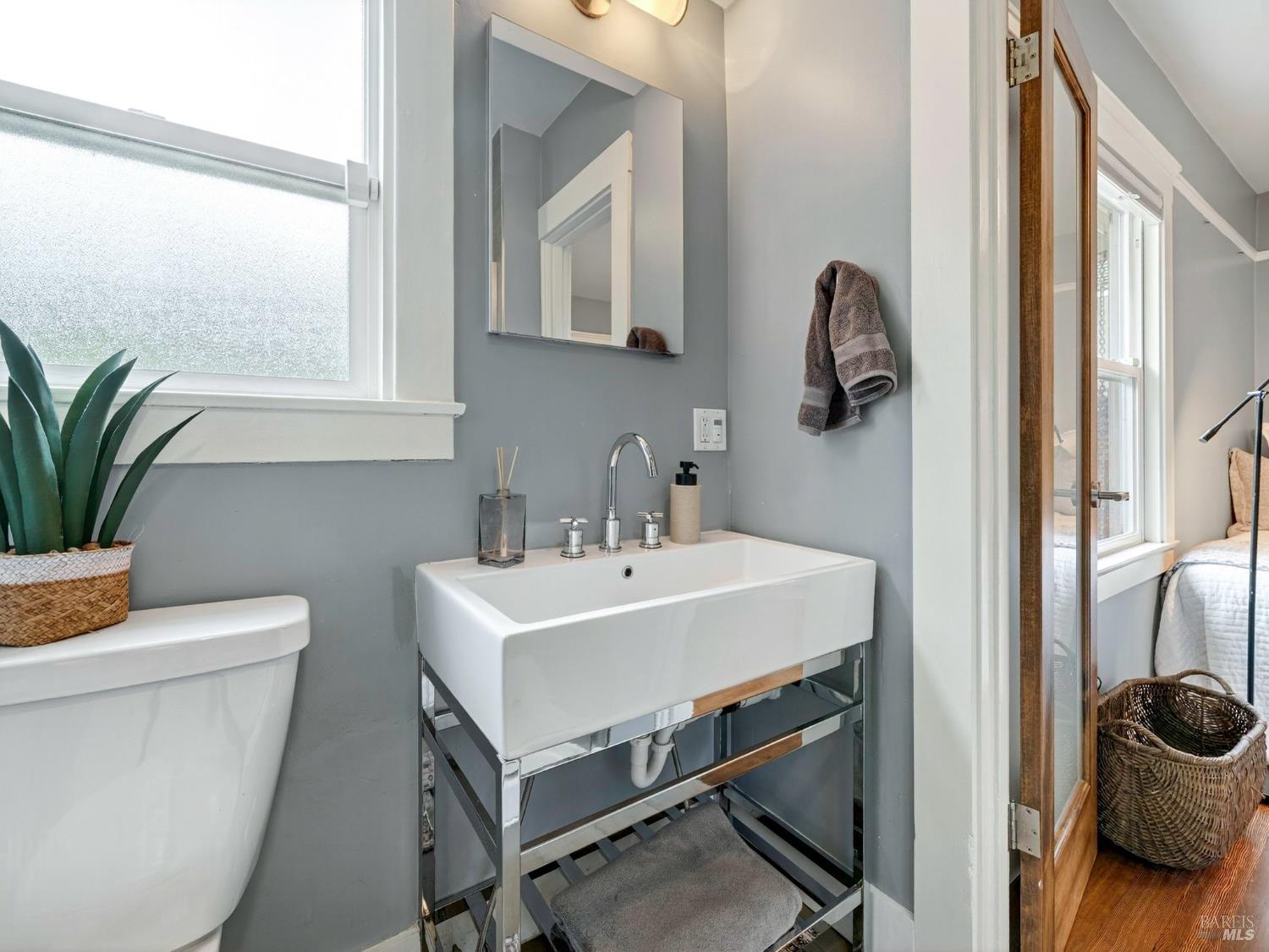 2 Bulson Court Napa, CA 94559 - Photo 22 of 30 a bathroom with a sink a toilet and a mirror