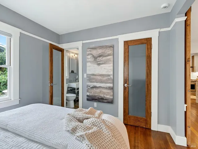 a bedroom with a bed and a large window