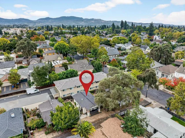 an aerial view of a house with a yard