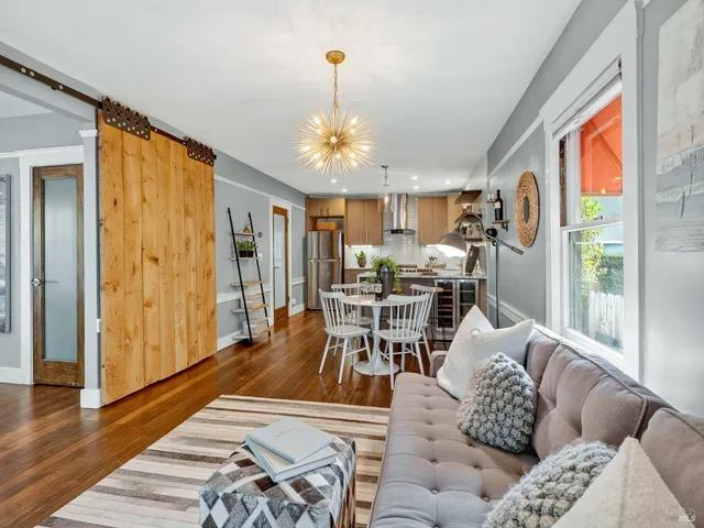 a living room with furniture and a chandelier