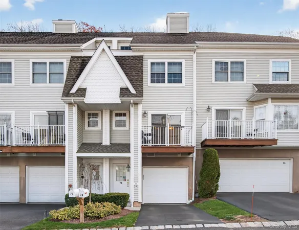 a front view of a residential apartment building with a yard