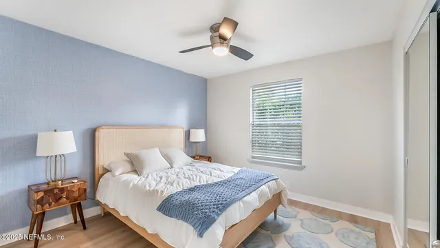 a bedroom with a bed and a lamp