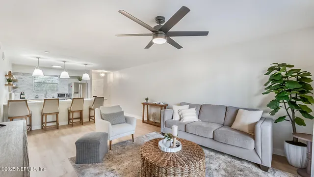 a living room with furniture and kitchen view