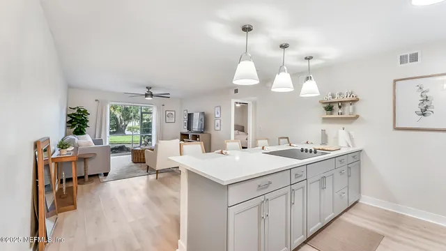 a kitchen with a white cabinets and stove