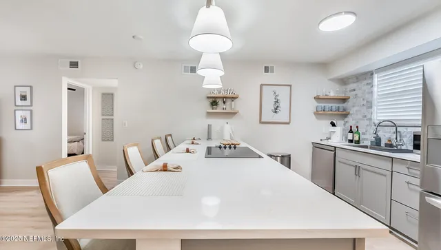 a room with a bed a chandelier and a mirror