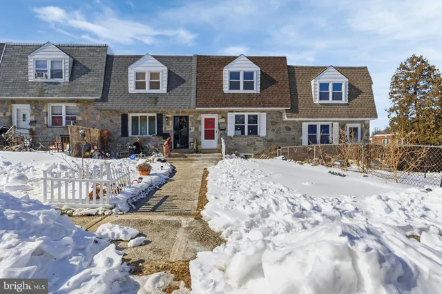 a view of a house with a snow in the background