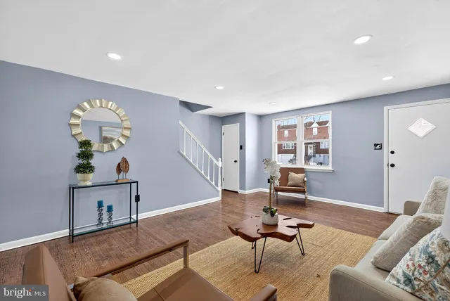 a living room with furniture and wooden floor