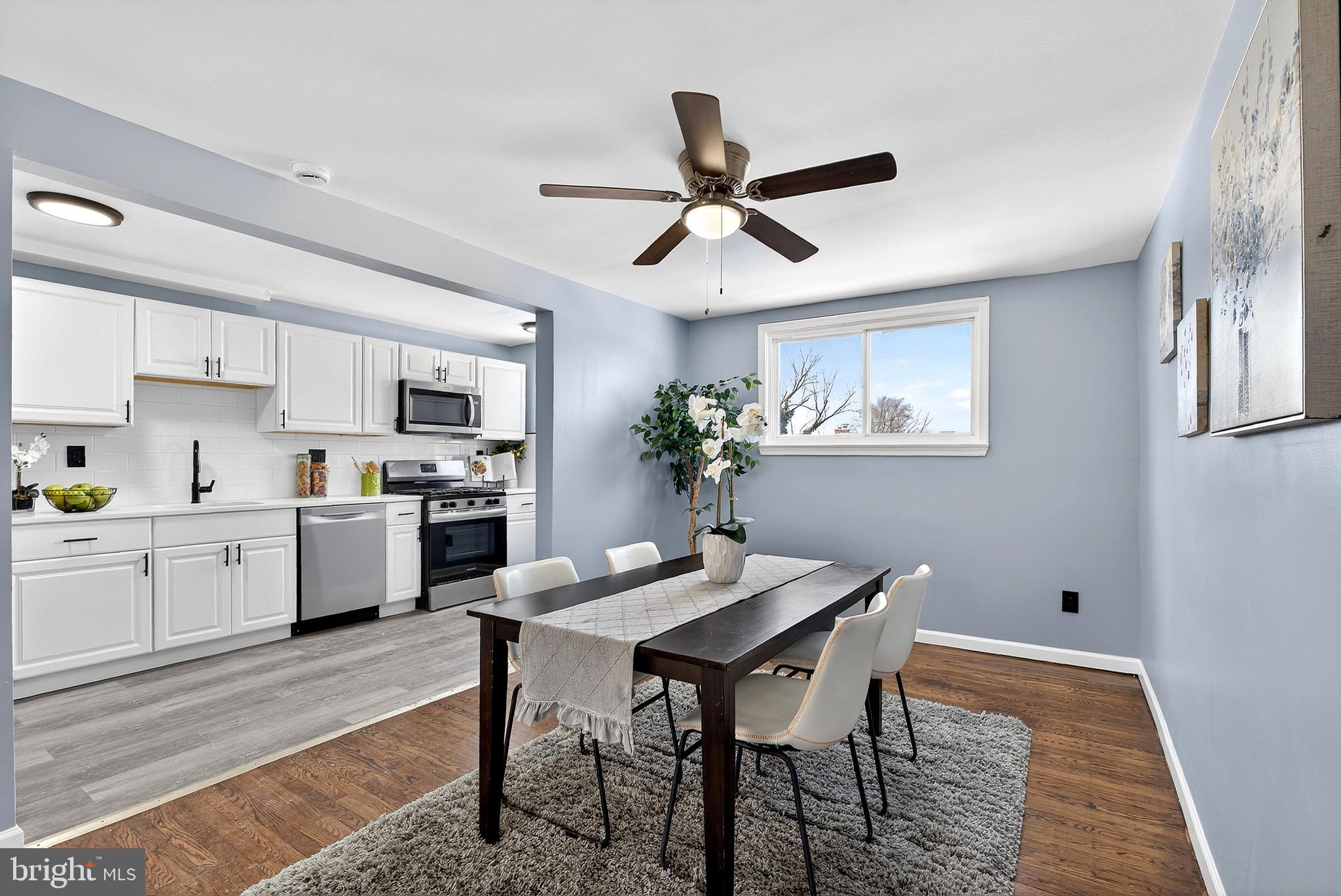 1216 Harshaw Road Brookhaven, PA 19015 - Photo 12 of 38 a kitchen with a dining table chairs stainless steel appliances and cabinets