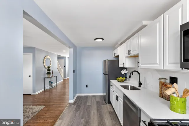 a kitchen with a sink a stove and cabinets