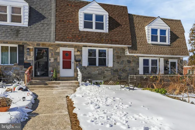 a view of a brick house with large windows