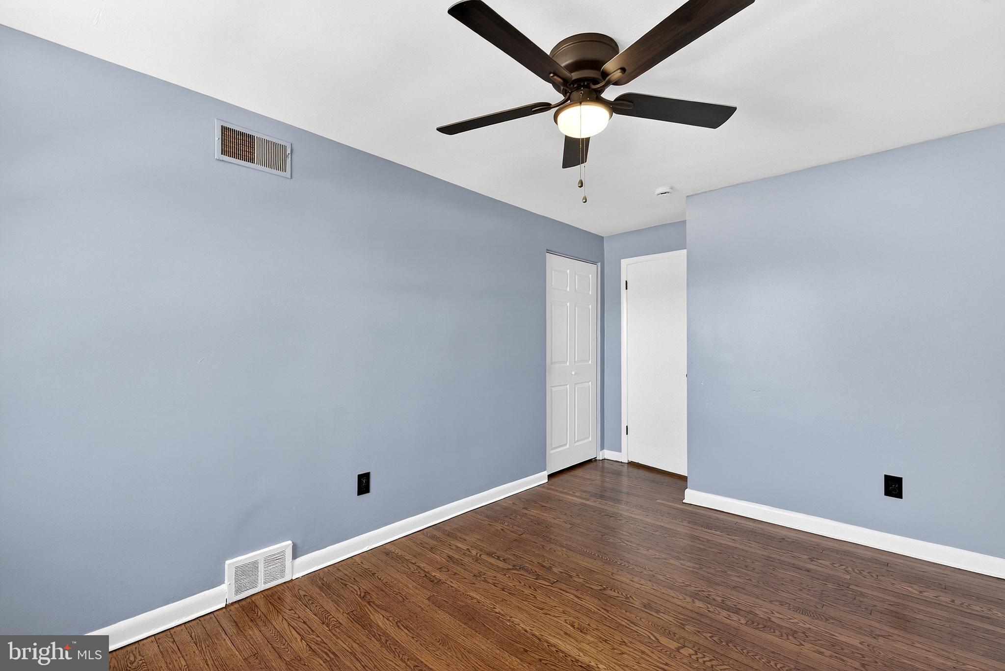1216 Harshaw Road Brookhaven, PA 19015 - Photo 28 of 38 an empty room with wooden floor and ceiling fan