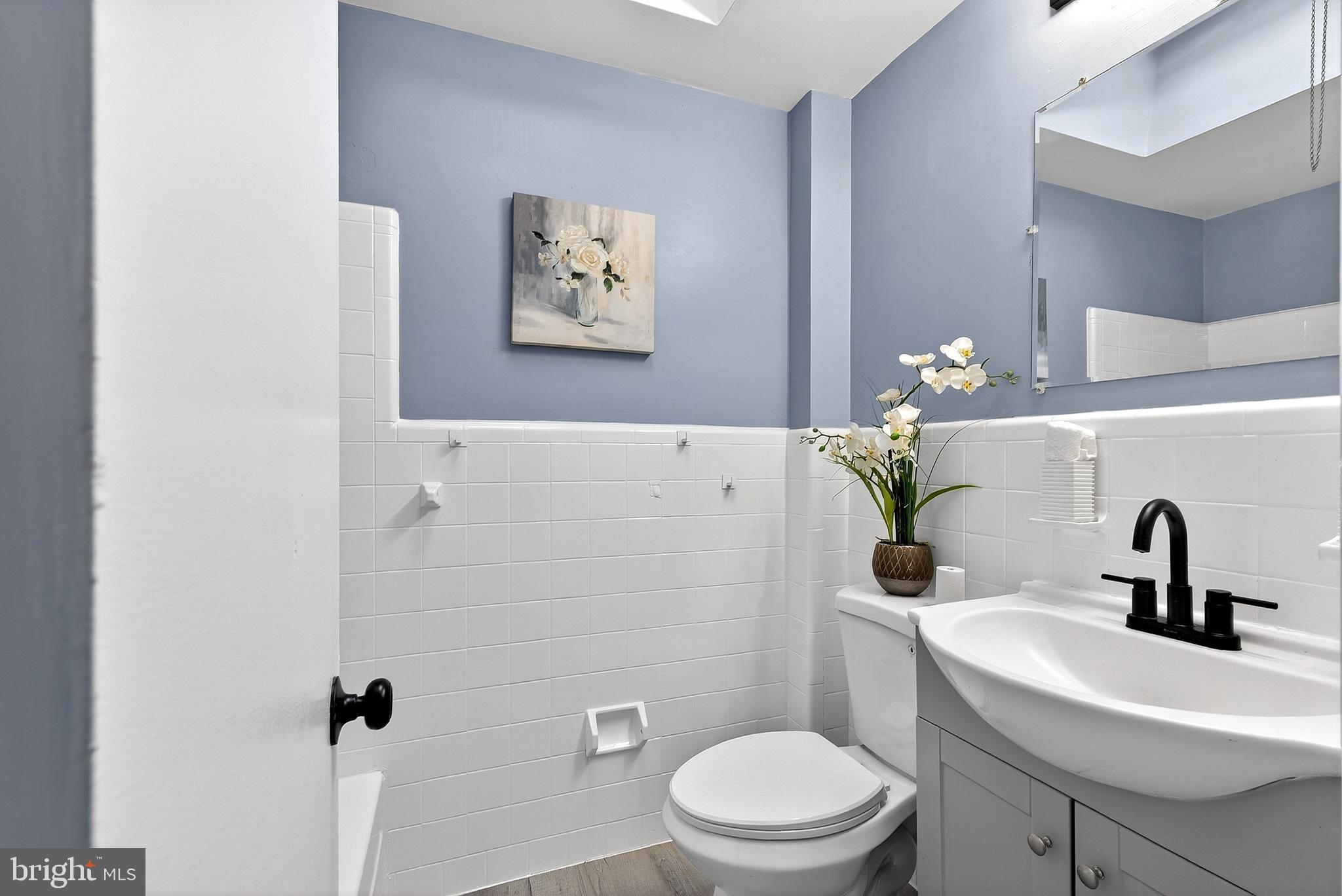 1216 Harshaw Road Brookhaven, PA 19015 - Photo 29 of 38 a bathroom with a sink a toilet and a mirror