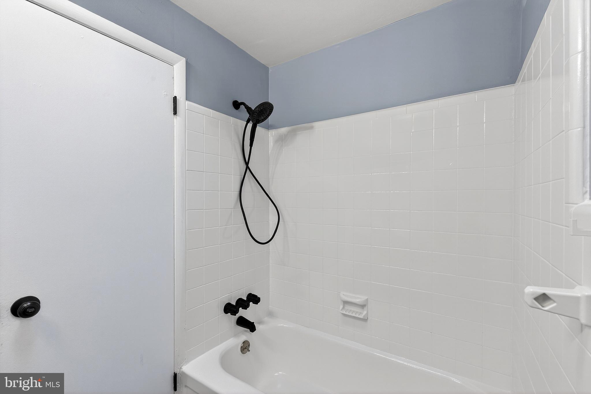 1216 Harshaw Road Brookhaven, PA 19015 - Photo 31 of 38 a bathroom with a bath tub with a shower