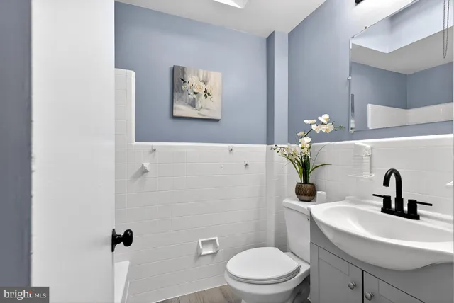 a bathroom with a sink a toilet and a mirror