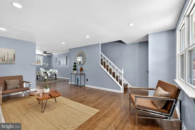 a living room with furniture and wooden floor