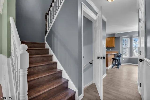a view of entryway and hall with wooden floor