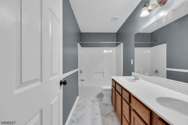 a bathroom with a double vanity sink a mirror and a shower