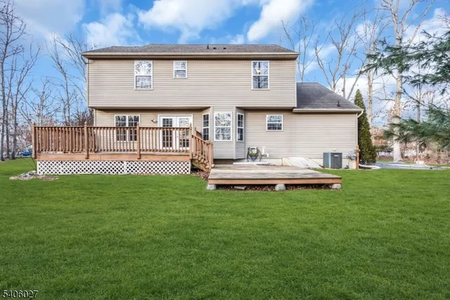 a front view of a house with a garden and yard