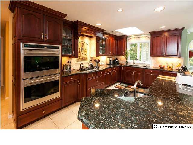 78 Knob Hill Road Morganville, NJ 07751 - Photo 2 of 3 a kitchen with a stove a sink and a microwave
