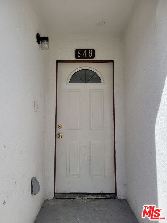 a view of front door with washer and dryer