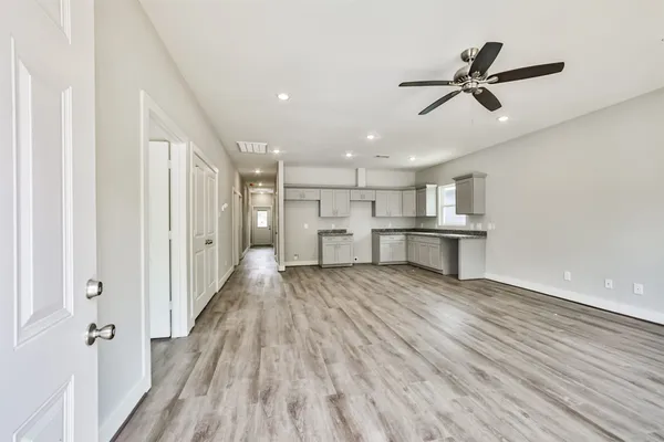 a view of a kitchen with wooden floor and a sink