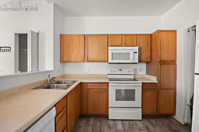 a kitchen with a sink stove and refrigerator