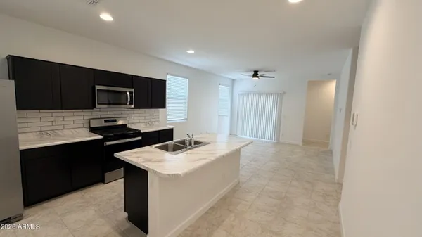 a kitchen that has a sink and a stove top oven