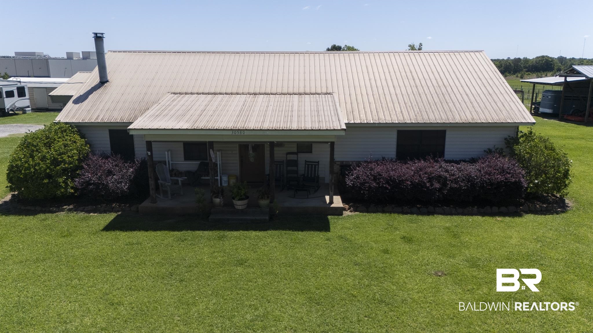 30580 County Road 49 Loxley, AL 36551 - Photo 1 of 32 Single-story home featuring a metal roof and a covered porch entry