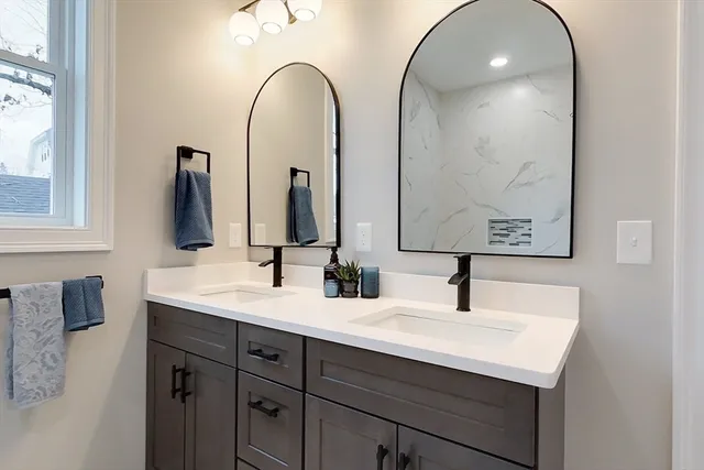 a bathroom with a double vanity sink and a mirror