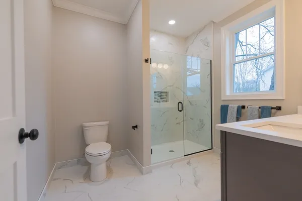 a bathroom with a toilet sink and a shower