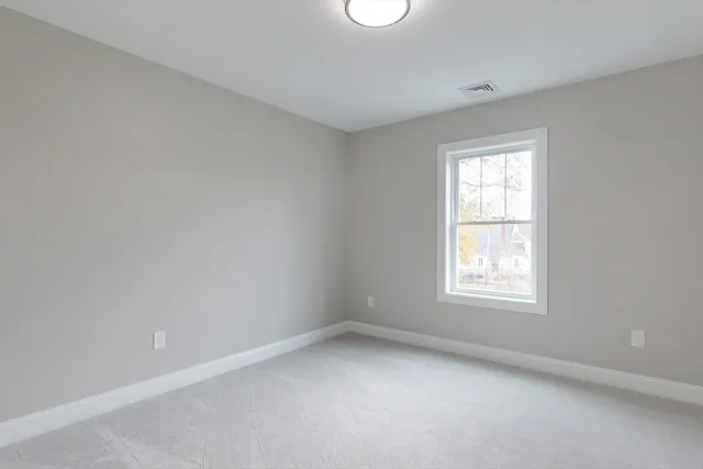 a view of an empty room and a window