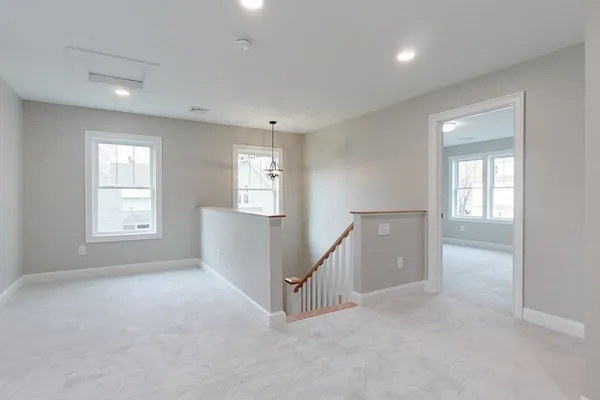 an empty room with windows and pillars in it