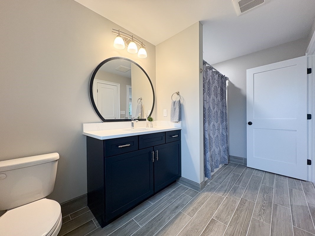 10 Pleasant Street Templeton, MA 01436 - Photo 31 of 41 a bathroom with a toilet a sink and a mirror