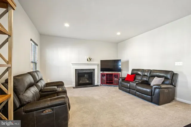 a kitchen with stainless steel appliances granite countertop a stove a sink dishwasher a refrigerator with a dining table and chairs