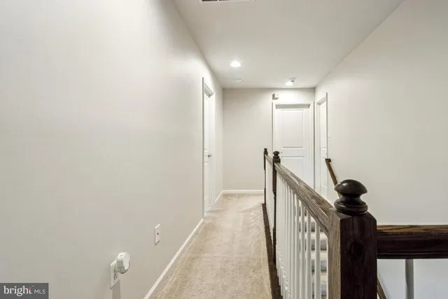 a bedroom with a bed lamp and a window