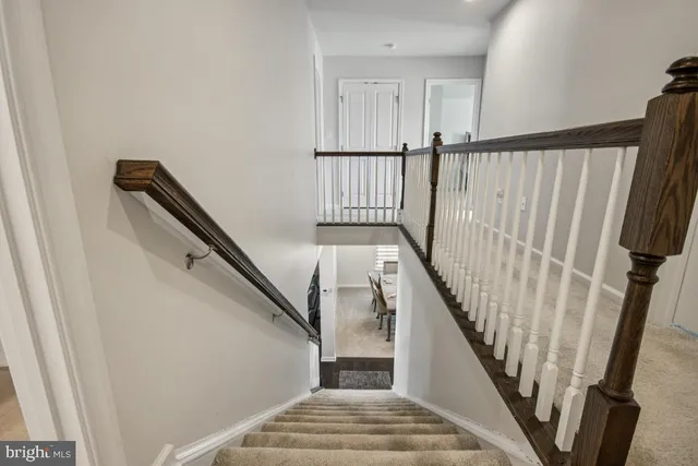 a view of a house with a big yard and large trees