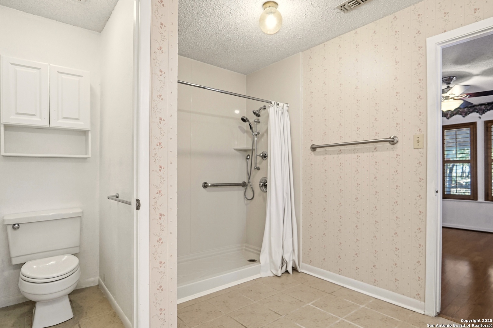 261 Fawn Lane Spring Branch, TX 78070 - Photo 13 of 36 a bathroom with a granite countertop shower and a toilet